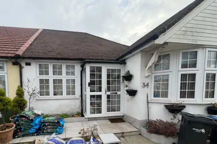 Bungalow with bay windows before its re-roof in north London