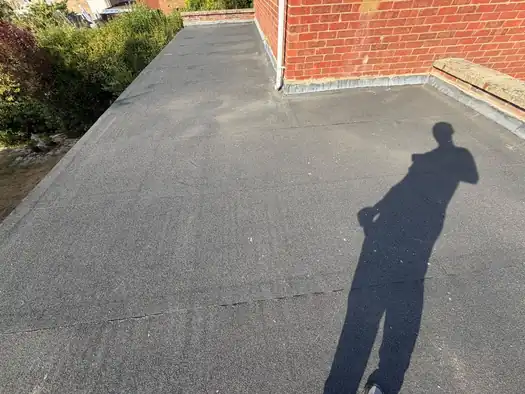 Felt flat roof finished up to a brick parapet wall