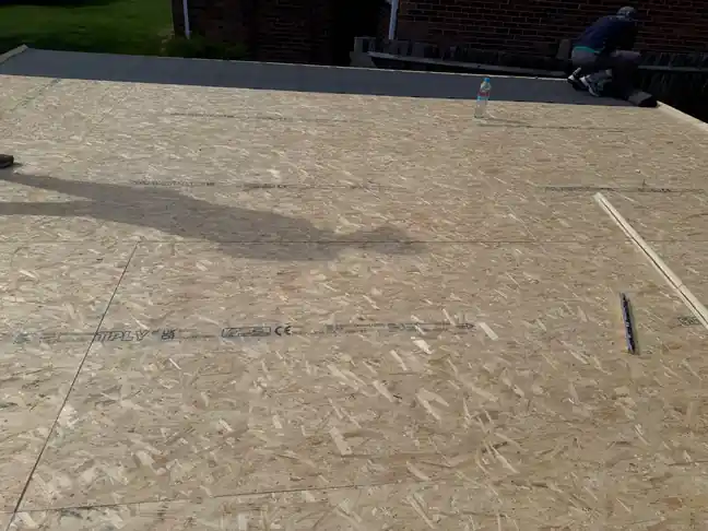 New OSB deck installed across a flat roof