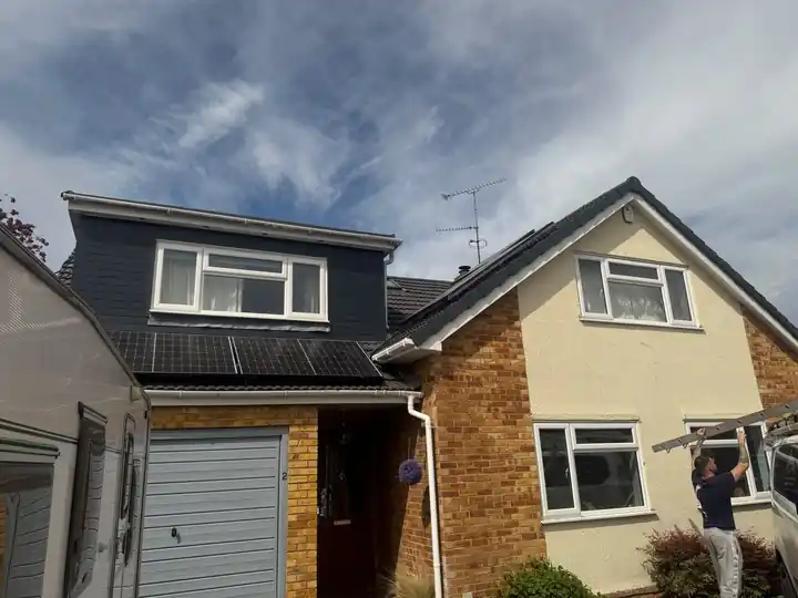 Front of a house with grey clad dormer and new tile roof