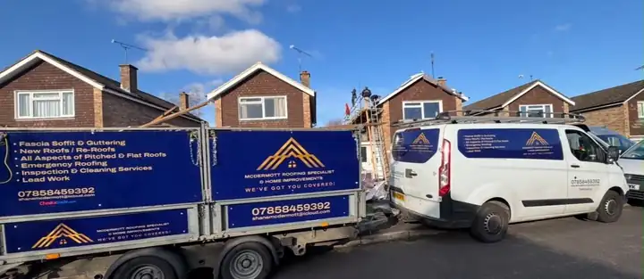 McDermott branded trailer and van parked outside a job