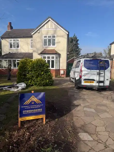 McDermott Home Improvements van and site sign on the driveway of a detached house