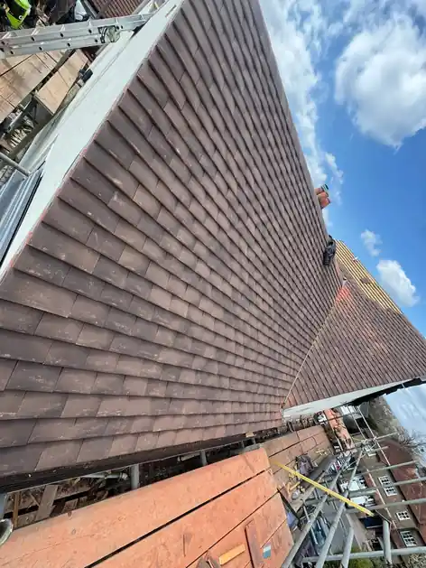 New plain tiles running down a slope of the Farnham roof