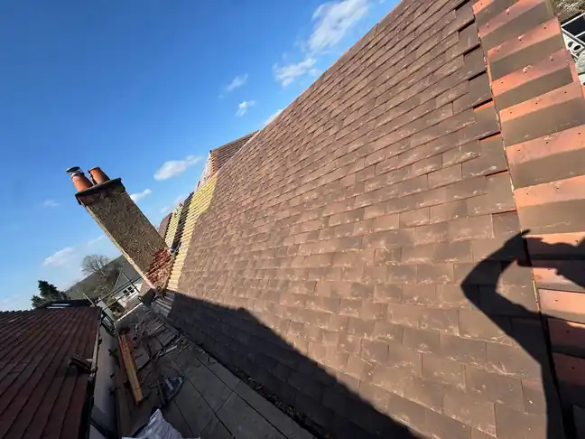 Complete new plain tile roof in Farnham beside the chimney stack