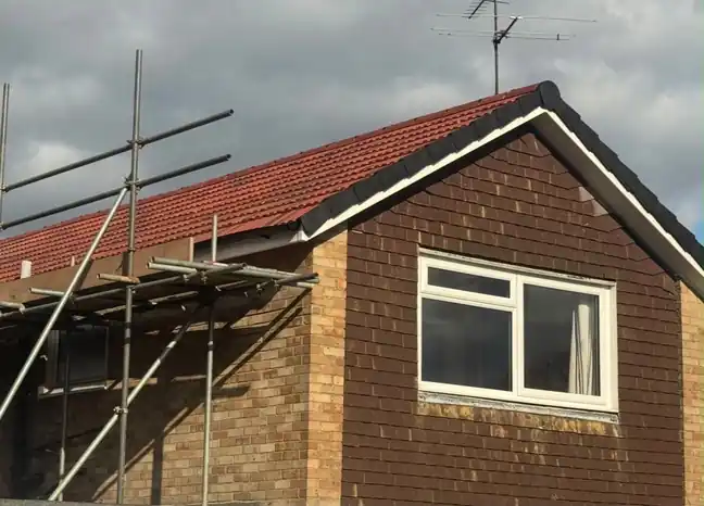 Ripley new roof in red tiles with new fascia, scaffold still up