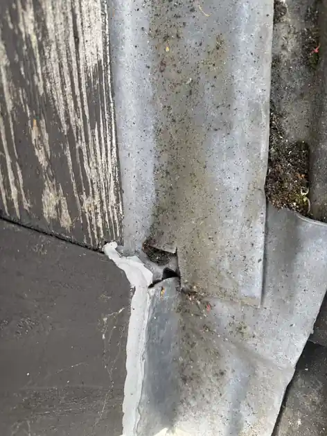 Split in old flat roof felt at a joint