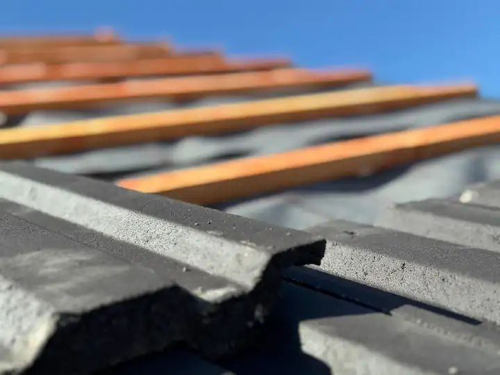 Treated tile battens and grey tiles on a new roof