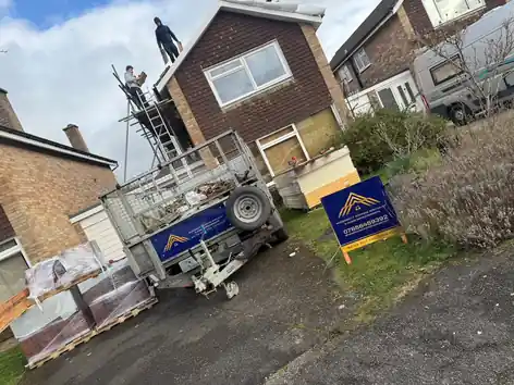 Tiles delivered on pallets with trailer for a re-roof